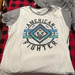 It’s a white with rainbow lettering women’s american fighter t shirt.